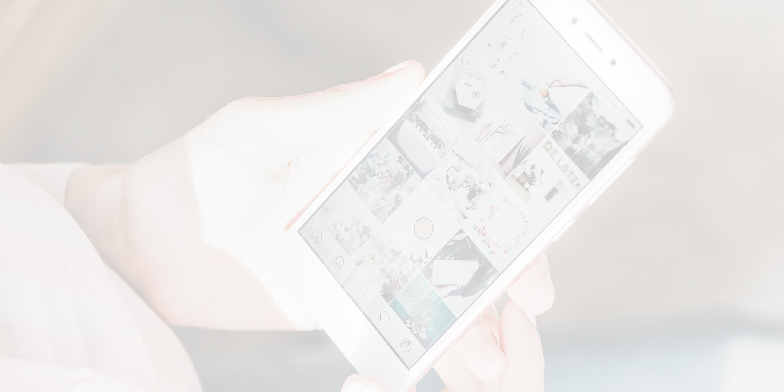 Person holding smartphone displaying social media content.