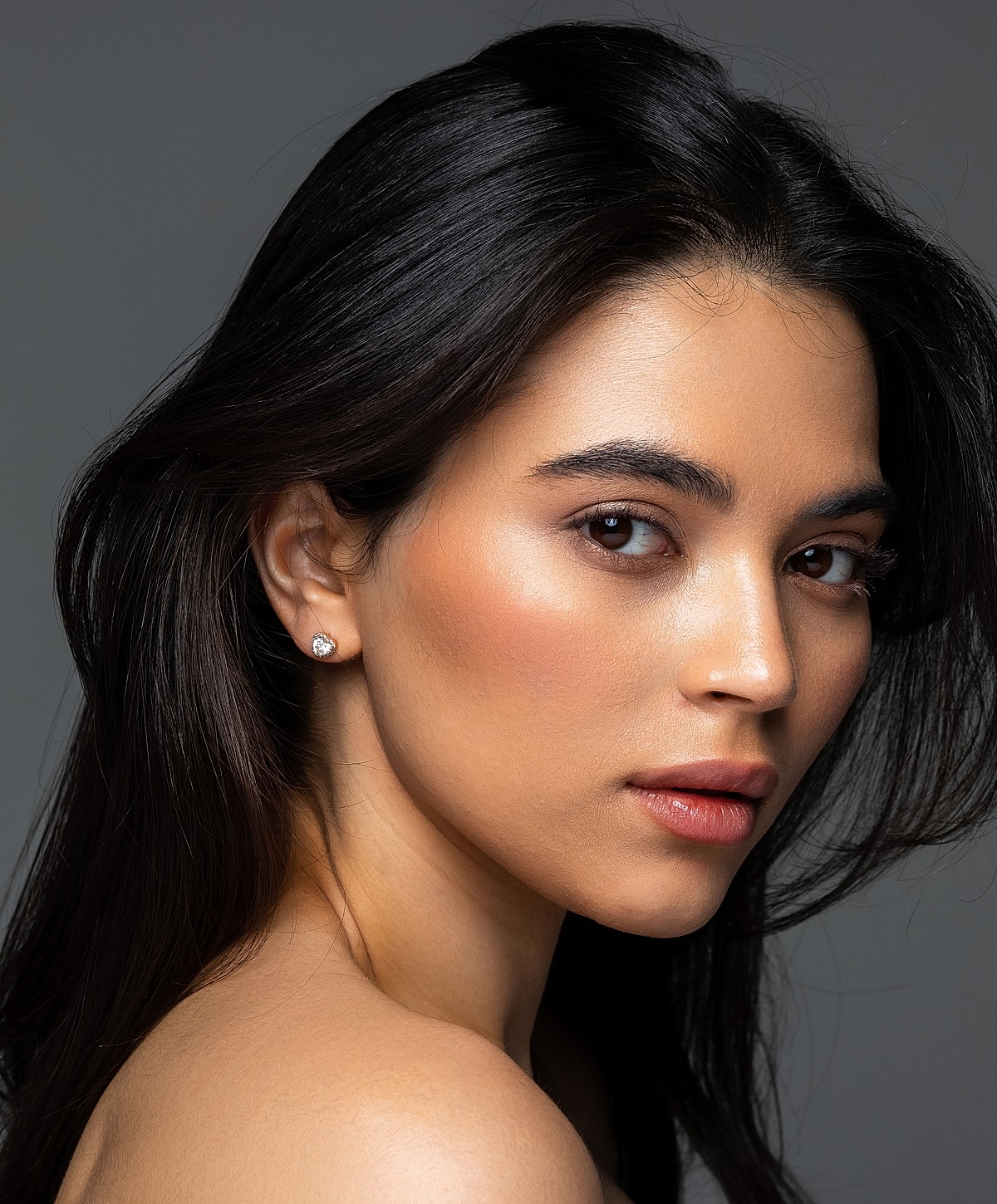 Portrait of woman with long dark hair.
