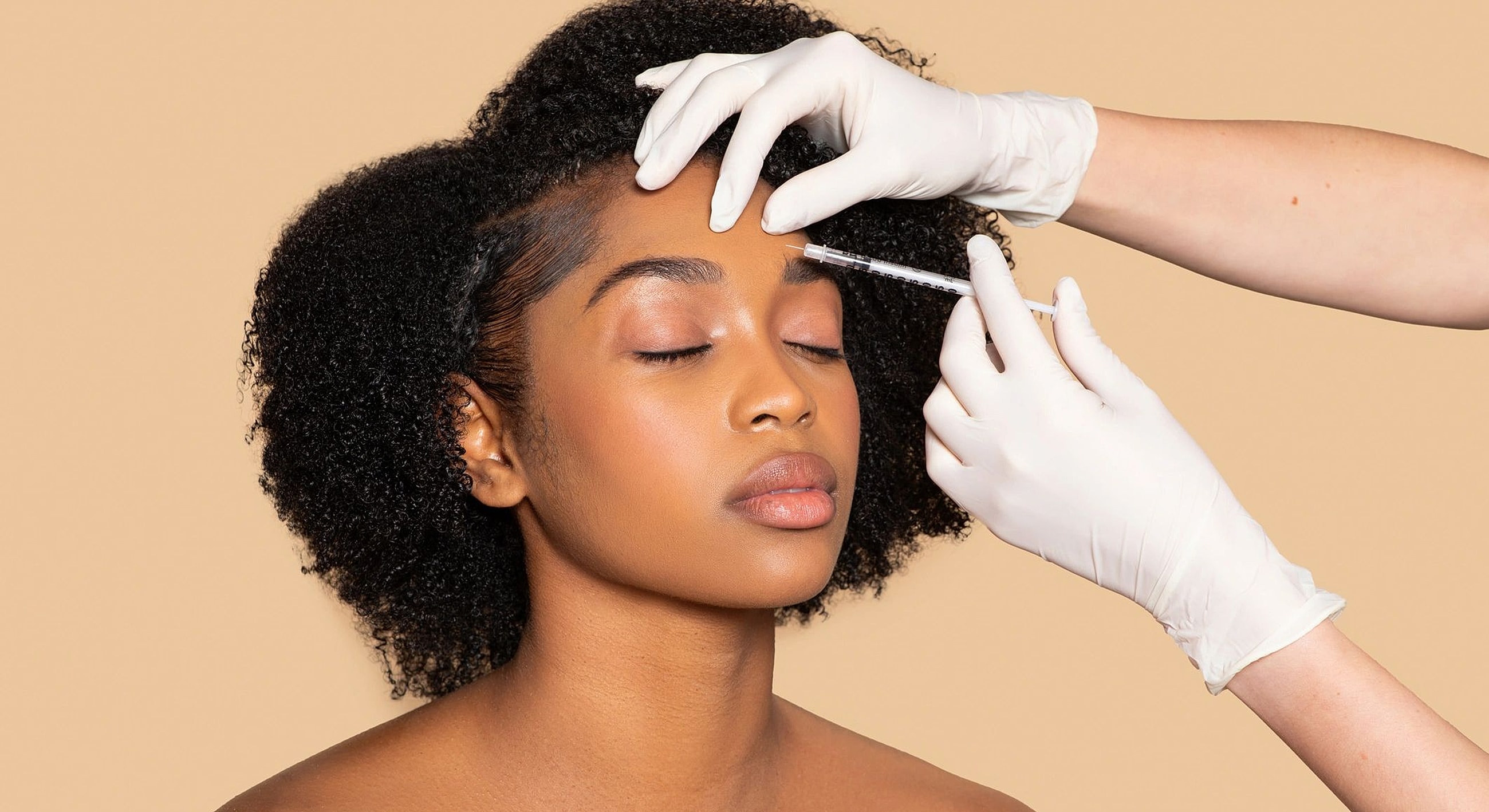 Woman receiving a cosmetic injection treatment.
